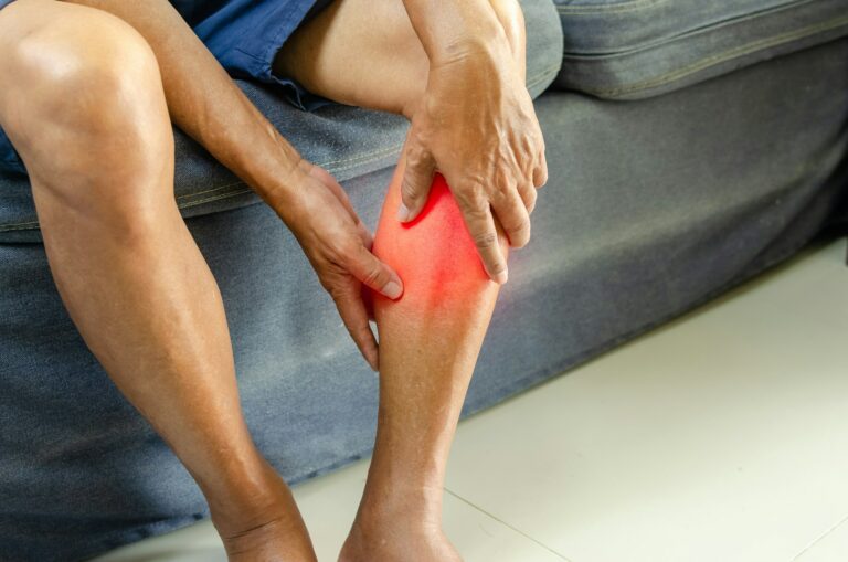 Injury or knee pain of an elderly man on the sofa.